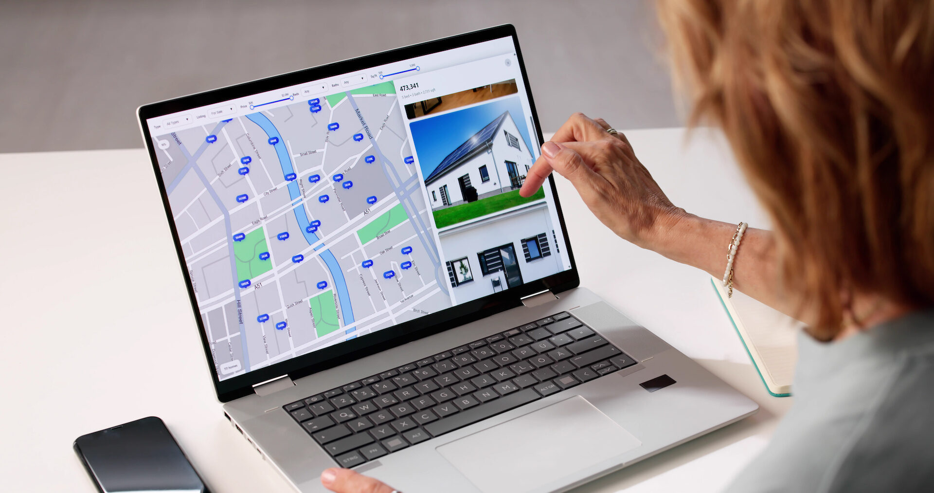 Real estate agent navigates online property search for private listings.